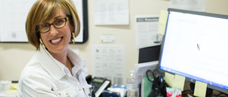 Smiling woman working at her workstation.